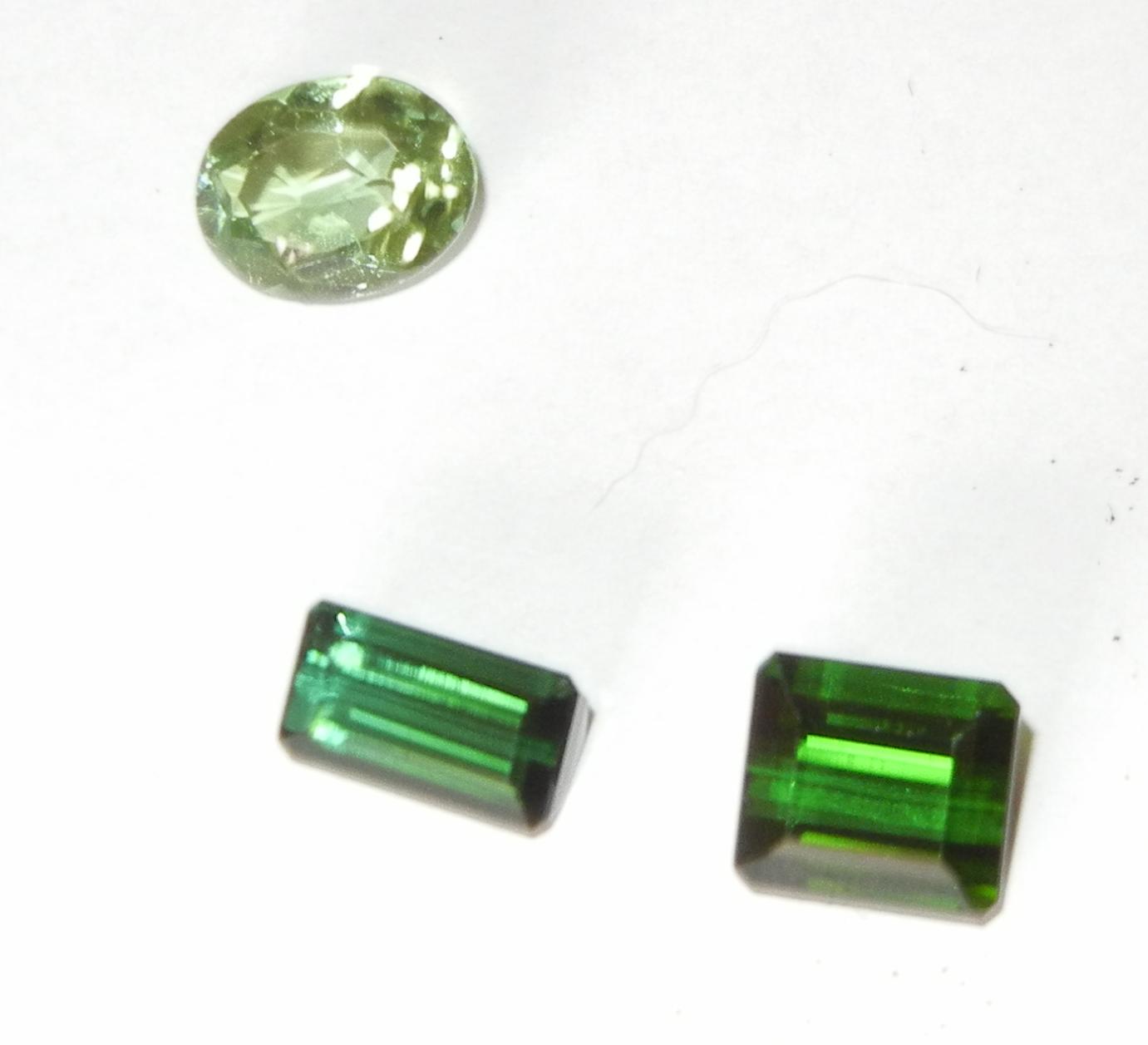 two dark-green rectangular tourmaline stone and one oval tourmaline stone