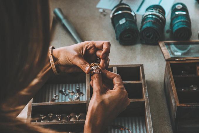 Picture of a woman sorting her jewelry in a storage box
