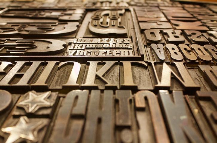 Image of different font letters on a wooden table