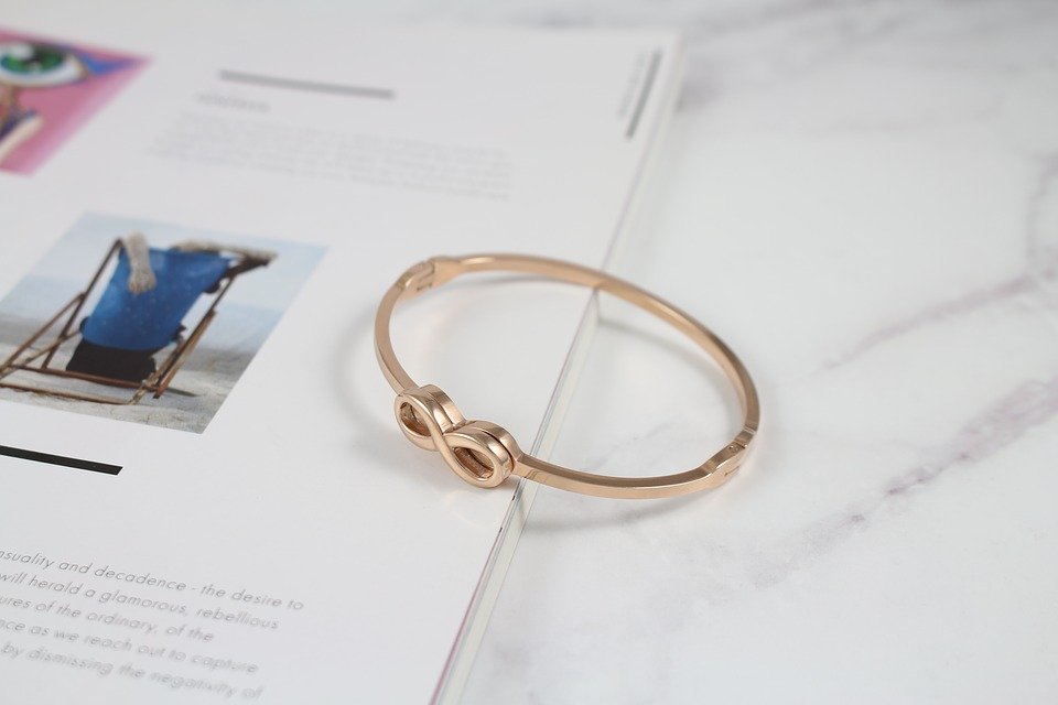 A rose gold bangle with infinity detail