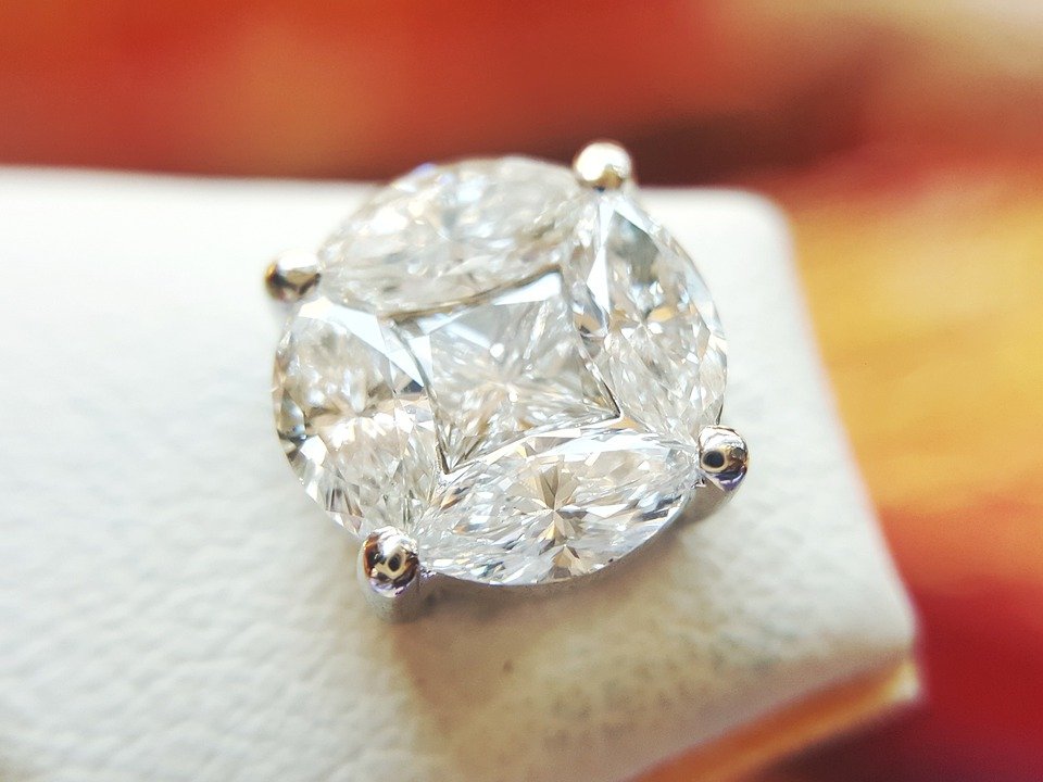 A close up photo of round diamond earring