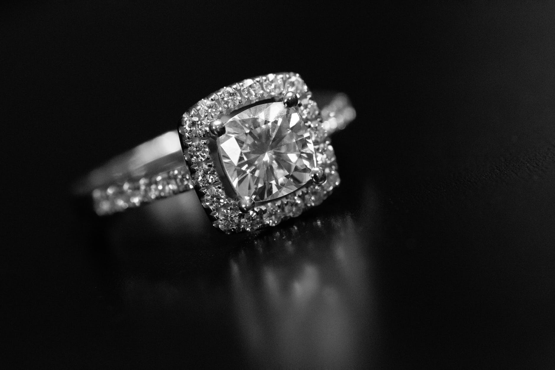 A cushion cut engagement ring studded with stones