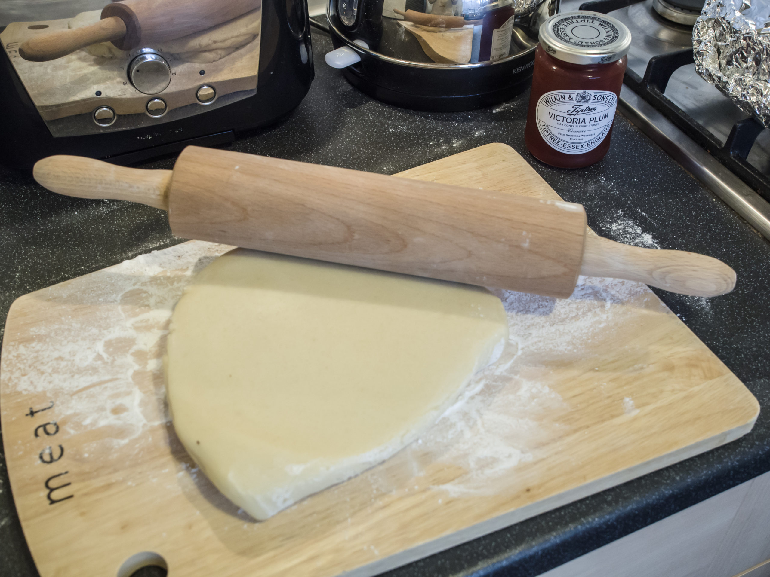 Plain marzipan being rolled flat