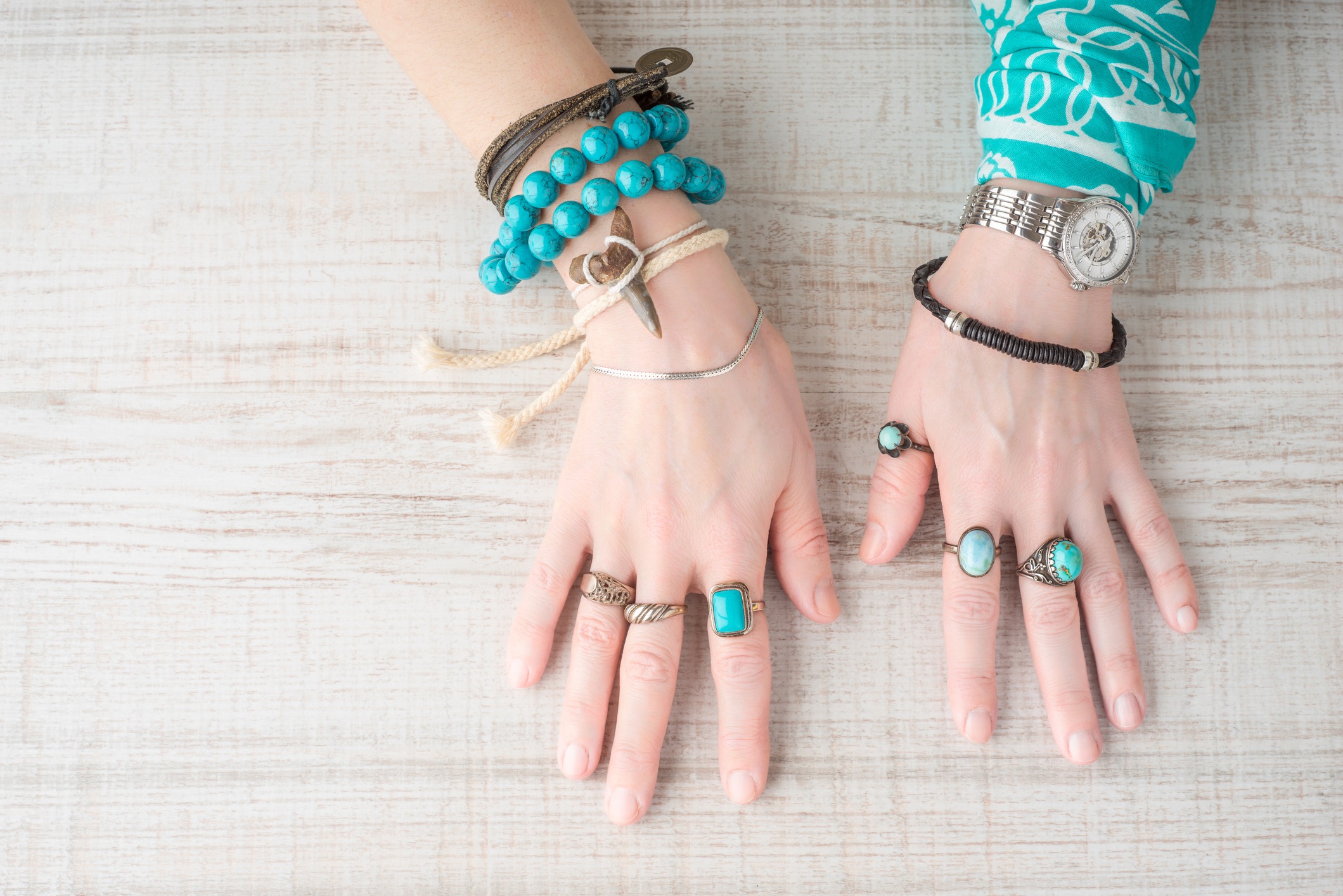 Hands of women in the jewelry of turquoise horizontal