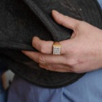a-gold-signet-ring-with-diamonds-women-on-a-man’s-finger