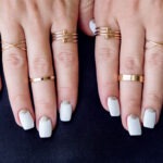 delicate-gold-stackable-ring-designs-worn-on-a-woman’s-fingers